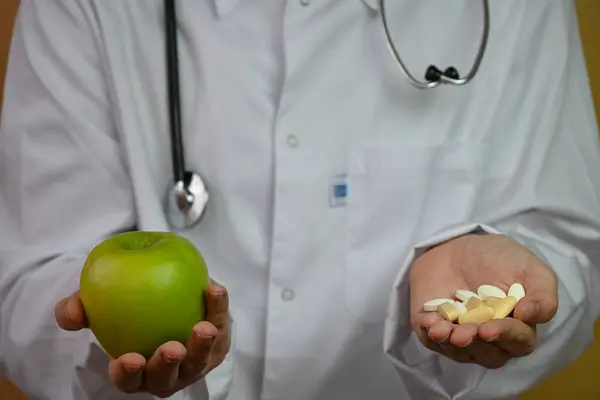 a doctor in a white coat with pills in one hand and an apple in the other warns about the consequences of an unhealthy lifestyle.