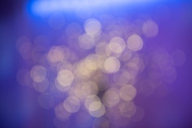 Abstract Bokeh Background with Soft Purple and Blue Hues and Golden Light Circles clipart