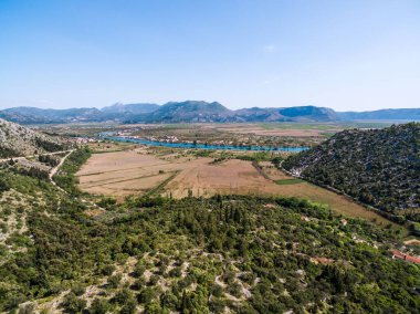 Expansive View of Neretva Valley with River Flowing Through Fertile Agricultural Land in Southern Croatia clipart