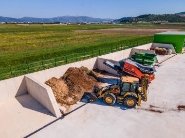 METKOVIC, CROATIA - 15 Nisan 2024: Sürdürülebilir Atık Yönetimi İçin Ağır Makineler ve Kompost Yığınlarıyla Endüstriyel Gübreleme Tesisi