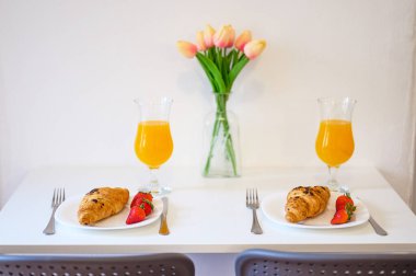 Delicious Croissants with Fresh Strawberries and Orange Juice Breakfast Setup Perfect Morning Dining Presentation clipart