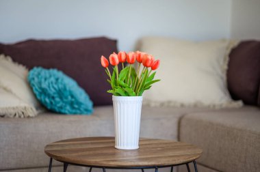 Parlak ve Havalı Oturma Odası Beyaz Kaburgalı Laleler Yuvarlak Ahşap Kahve Masasında