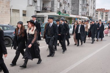 METKOVIC, CROATIA - 19 Şubat 2023: Yıllık maskeli balo festivali sırasında eski moda ve retro-ilham dolu kostümler giymiş karnaval katılımcıları.