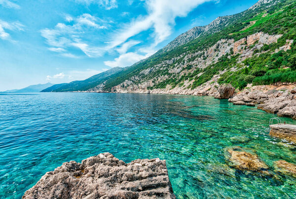 Scenic Coastal Landscape of the Peljesac Peninsula in Croatia Featuring the Adriatic Sea and Rocky Shoreline in the Dingac Region. Crystal clear sea, sky and beach.