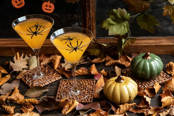 Preparation for Halloween. Autumn drink in glass on dark background