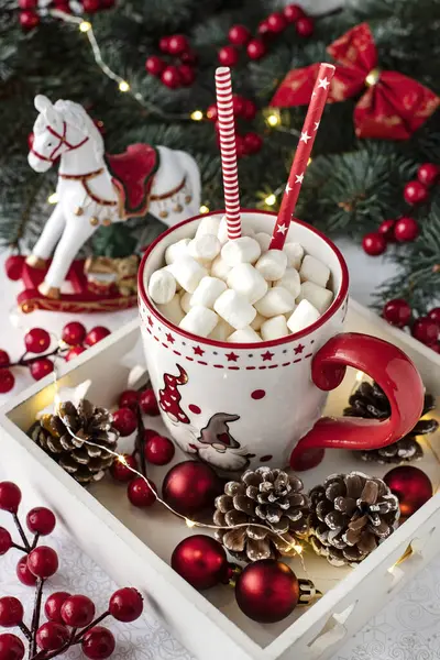 Cup of creamy hot chocolate with melted marshmallows for Christmas holiday
