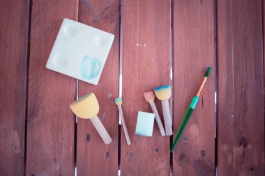 Ahşap bir masada bir sürü farklı boyutta fırça.