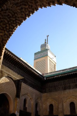 Fas, Fez 'deki Bou Inania Madrassa eğitim binasında güzel bir kule ve kemer.