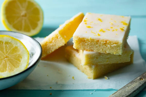 Fudgy Lemon Brownies Lemon Glaze Zest Baking Paper Aquamarine Background — Stock Photo, Image