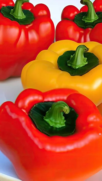 red and yellow peppers on a white background