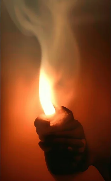 candle in the hands of a burning candles