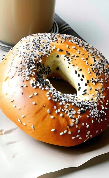 fresh bagel with sesame seeds and coffee on white background