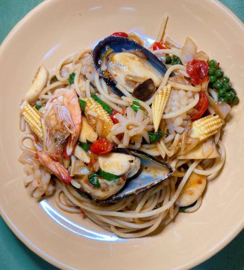 Deniz ürünleri ve mısırlı bir tabak makarna deniz ürünleri, mısır ve sebzeli araflı makarna.