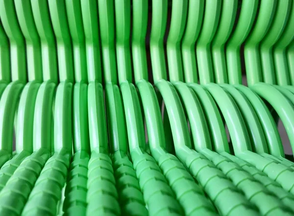 stock image a photography of a green chair with a lot of green plastic chairs, there is a green chair that has many green chairs in it