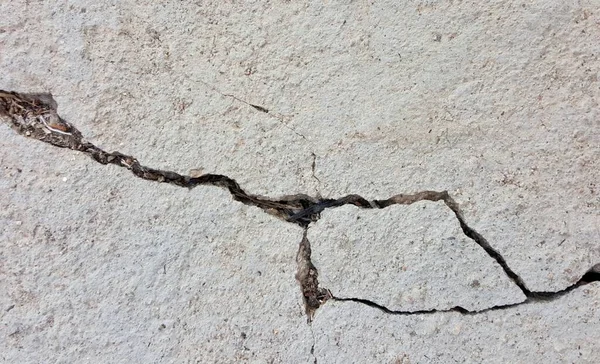 Beton bir duvarda zincirle bir çatlağa çivi çakmak.