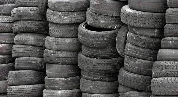 a photography of a pile of tires stacked on top of each other, araffature of a pile of tires stacked on top of each other.