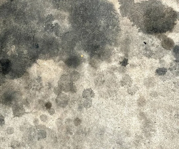 黒と白のパターンを持つ汚れたコンクリートの床の写真黒い斑点と白い背景を持つコンクリートの表面 — ストック写真