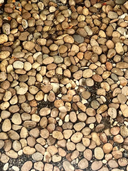 a photography of a pile of rocks and gravel on a ground, there is a pile of rocks and gravel on the ground.