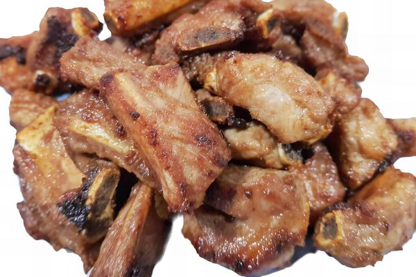 a photography of a pile of meat on a white plate, there is a pile of meat that is on a plate.