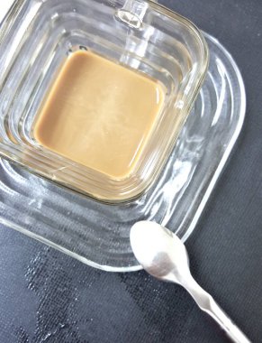 İçinde kaşık olan kare cam bir çanağın fotoğrafı. İçinde kaşık olan kare cam bir kase var..