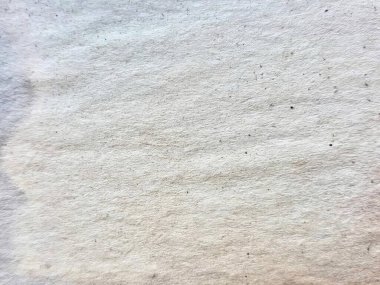 Küçük bir deliği olan beyaz bir duvarın, ortasında küçük bir delik olan beyaz bir kumaşın yünlü dokusu..