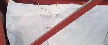 Beyaz levhalı kırmızı metal çerçeve, beyaz levha ve kırmızı saplı harman makinesi..