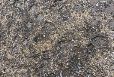 Siyah ve beyaz kayalardan oluşan bir duvarın dokusu.