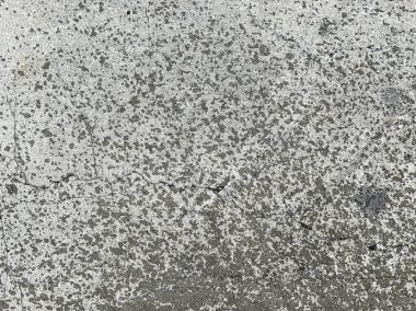 Beton bir duvarın dokusu ve gri bir arka plan..