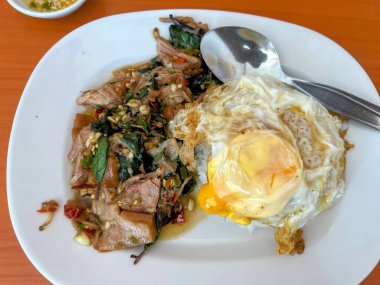 Çatal ve kaşıkla bir tabak yemeğin fotoğrafı..