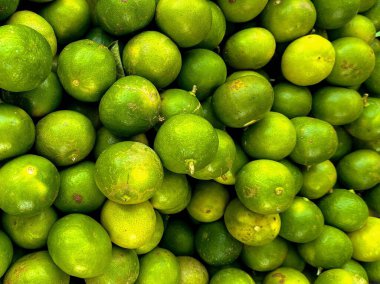 a photography of a pile of limes sitting on top of each other. clipart