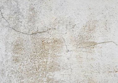 İçinde çatlak olan beyaz bir duvarın fotoğrafı..