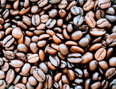 a photography of a pile of coffee beans with a brown tint. clipart