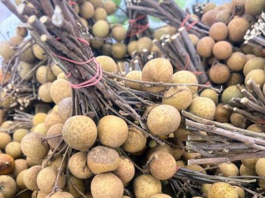 a photography of a bunch of longan fruit piled on top of each other. clipart