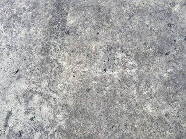 Çatlaklarla dolu beton bir yüzeyin fotoğrafı..