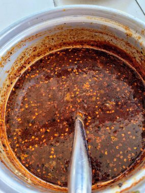 İçinde kaşık olan bir sos kabının fotoğrafı..