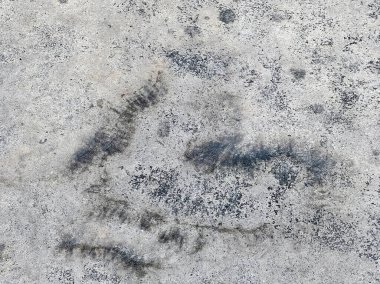 a photography of a dirty concrete surface with a black and white pattern. clipart