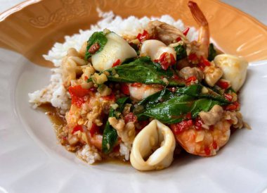 Pirinç ve sebzeli bir tabak yemeğin fotoğrafı..