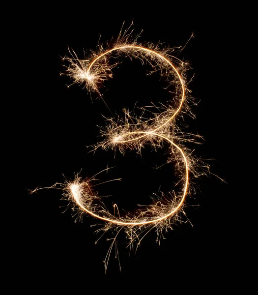 Sparkling burning creative number 3 isolated on black background. Beautiful glowing golden overlay object for design holiday greeting card. Creative lettering number 3 written with burning sparklers