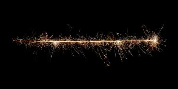 Sparkling burning creative golden line written with burning sparklers isolated on black background. Beautiful glowing golden overlay object for design of holiday greeting card, banner, flyer, poster