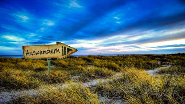 stock image Image shows a signpost and a sign in the direction of emigration and wanderlust in German.