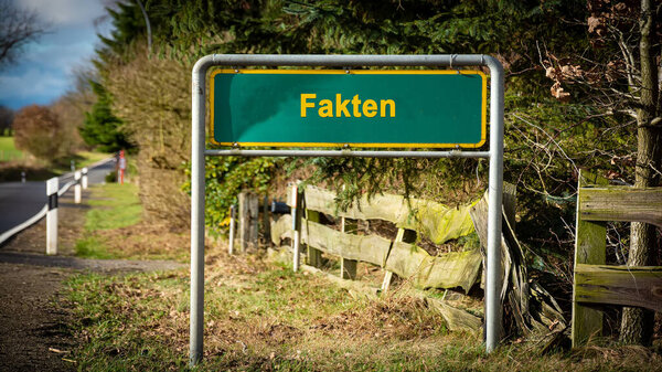 picture shows a signpost and a sign pointing to facts in german.