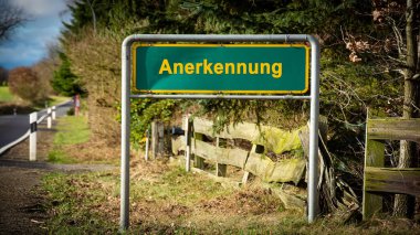 Resim, Almanca kazanılan tanınma yönünü gösteren bir işaret levhası ve işaret levhası gösteriyor..