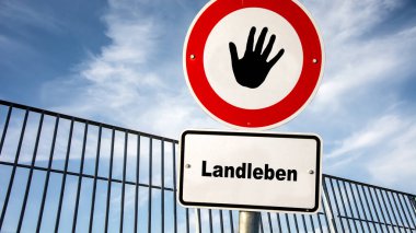 Almanca 'nın iki farklı yönünü gösteren işaret direği olan bir resim. Bir yön şehir yaşamını gösteriyor, diğeri de kırsal yaşamı..