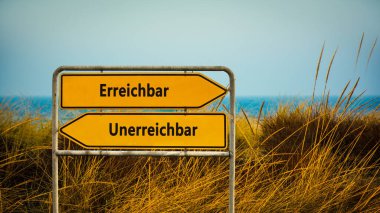 Almanca 'nın iki farklı yönünü gösteren işaret direği olan bir resim. Bir yön ulaşılamaz, diğeri ulaşılamaz diyor..