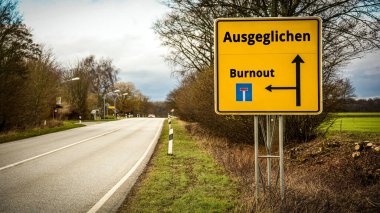Almanca 'nın iki farklı yönünü gösteren işaret direği olan bir resim. Bir yön Dengeli 'yi, diğeri Burnout' u gösteriyor.