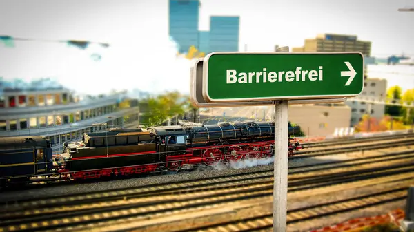 stock image the picture shows a signpost and a sign pointing in the direction of barrier-free in german