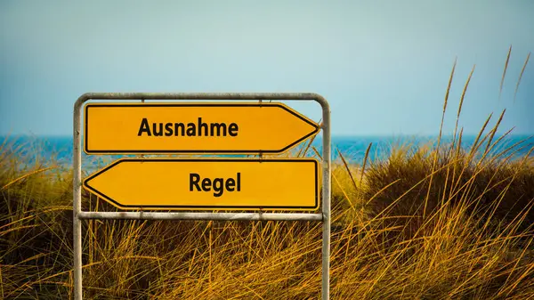 stock image An image with a signpost pointing in two different directions in German. One direction points by exception, the other points by rule.