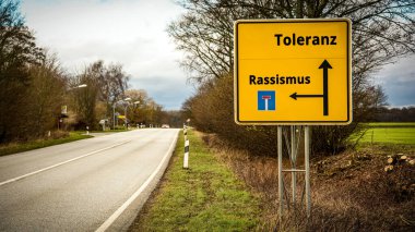 An image with a signpost pointing in two different directions in German. One direction points to racism, the other points to tolerance. clipart