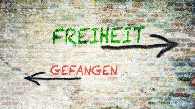 Almanca 'nın iki farklı yönünü gösteren işaret direği olan bir resim. Bir yön özgürlüğü, diğeri esiri işaret ediyor..