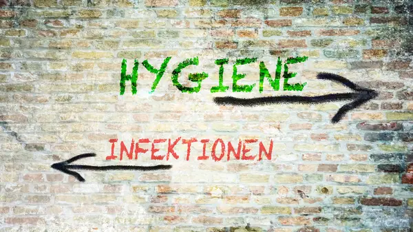 Almanca 'nın iki farklı yönünü gösteren işaret direği olan bir resim. Bir yön hijyene, diğeri enfeksiyonlara işaret ediyor..